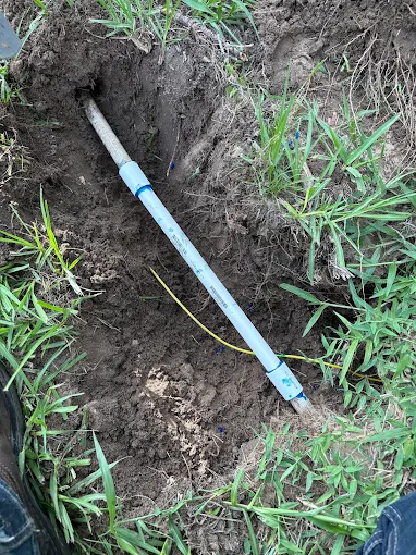 Repaired irrigation main line in an open trench