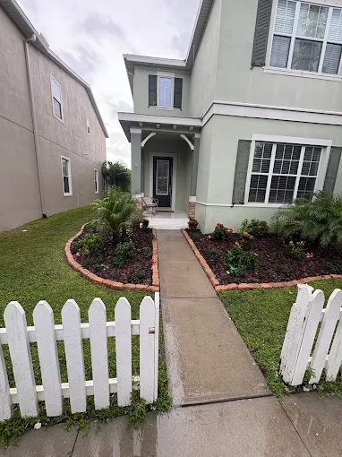 Front yard flower beds with brick edging and fresh mulch